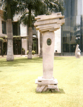 Hotel garden stone sculpture installation creating serene architectural focal point