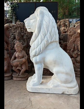 Dynamic pink marble Hanuman sculpture in devotional pose with detailed muscular definition and traditional iconography